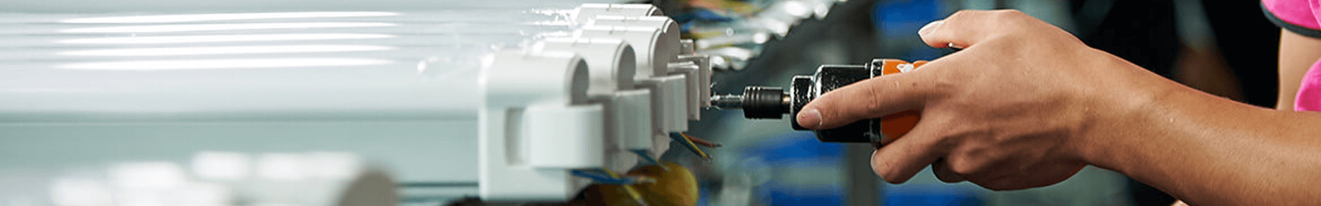 Technician assembling a linear LED tri-proof light